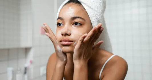 a lady cleansing her face