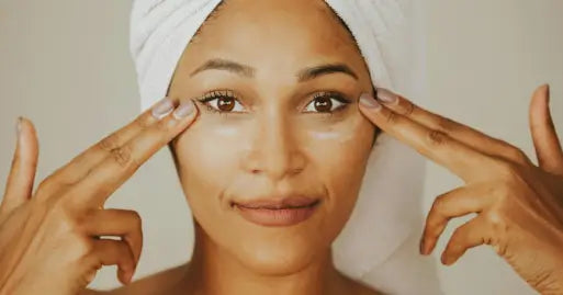 woman applying cream on her face